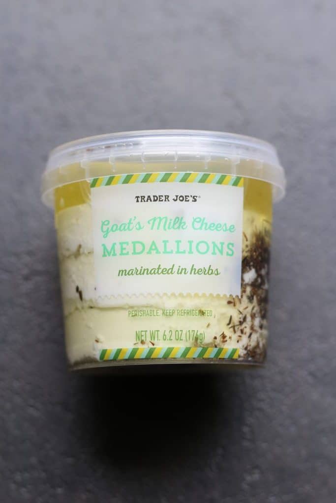 An unopened package of Trader Joe's Goat’s Milk Cheese Medallions Marinated in Herbs