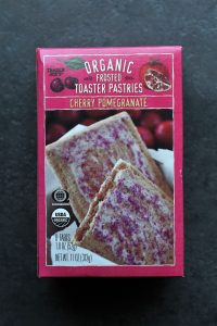 Trader Joe's Organic Frosted Cherry Pomegranate Toaster Pastries box on a dark surface