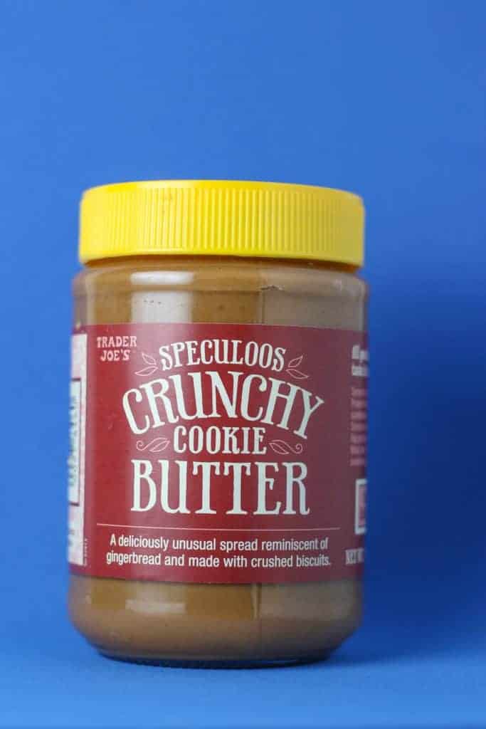 Trader Joe's Speculoos Crunchy Cookie Butter in a jar with a blue background.