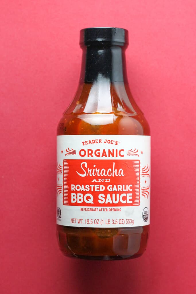 An unopened bottle of Trader Joe's Sriracha and Roasted Garlic BBQ Sauce
