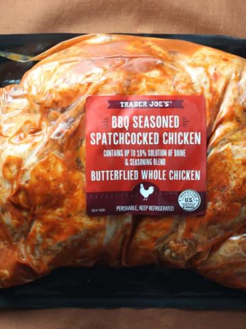Trader Joe's BBQ Seasoned Spatchcocked Chicken package on a brown tablecloth