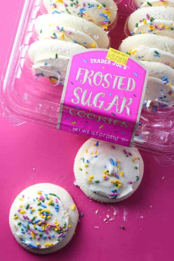 Trader Joe's Frosted Sugar Cookies out of the package and on a pink background