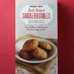 An unopened box of Trader Joe's Soft Baked Snickerdoodles box on a red background