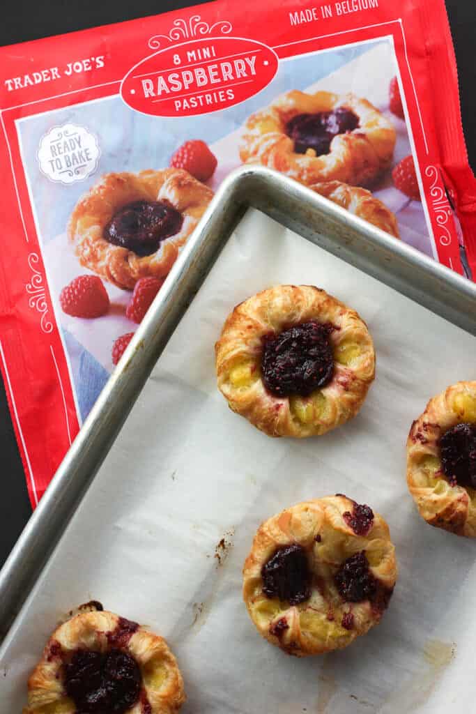 Trader Joe's 8 Mini Raspberry Pastries baked next to the bag for a compairson