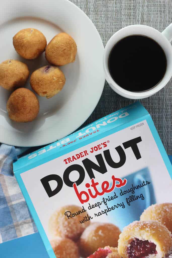 Fully cooked Trader Joe's Donut Bites with coffee, a napkin and the original box