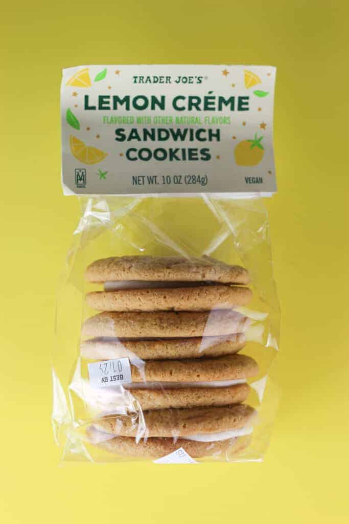 An unopened bag of Trader Joe's Lemon Creme Sandwich Cookies on a yellow background