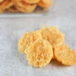 Four of my parmesan crisps next to the glass bowl of crisps
