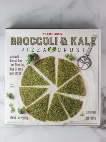 An unopened box of Trader Joe's Broccoli and Kale Pizza Crust on a marble surface