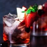 Two finished Red Russian cocktails on a dark board with a dark background