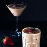 Two finished Nuts and Berries Cocktails. The one in front is in a rocks glass with ice the one in the background is served in a martini glass. However, the rocks glass is in focus.