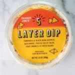 Trader Joe's 5 Layer Dip review pin showing an unopened package of the dip for Pinterest