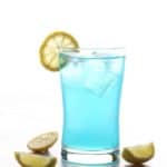 An back lit picture of a single glass of electric lemonade with sliced lemons around it