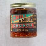 An unopened jar of Trader Joe's Chili Onion Crunch