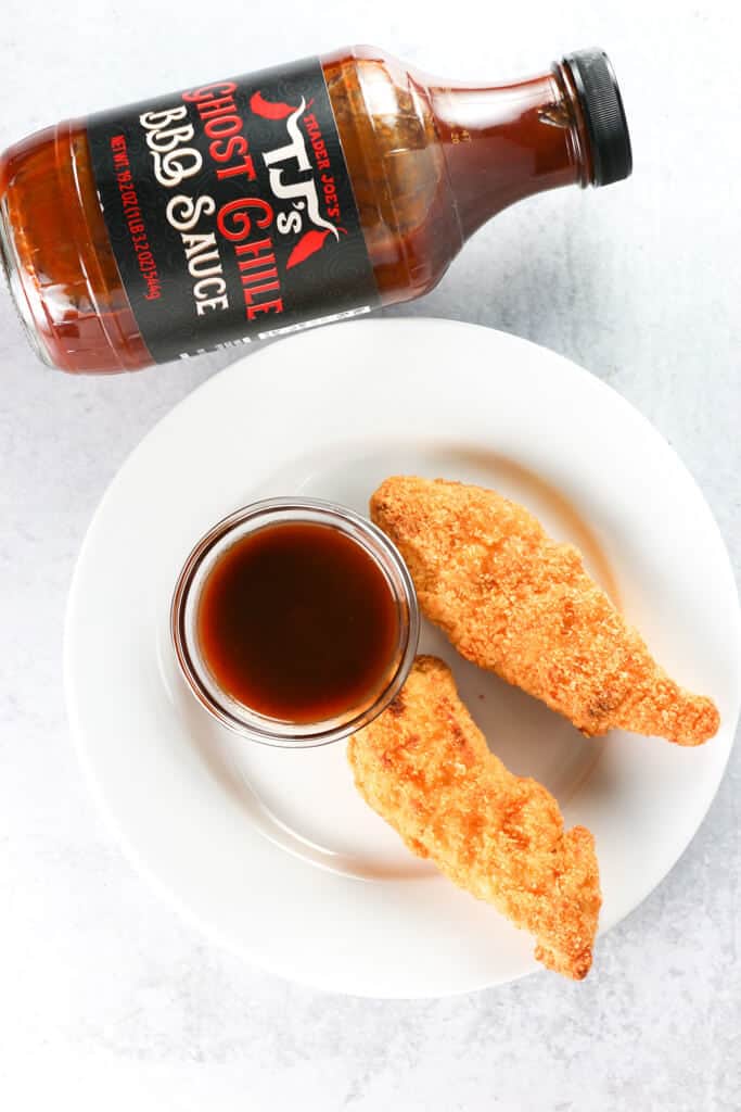 Two chicken tenders with a side of Trader Joe's Ghost Chile BBQ Sauce