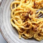 My copycat Trader Joe's Chili Onion Crunch on top of a bowl of linguine