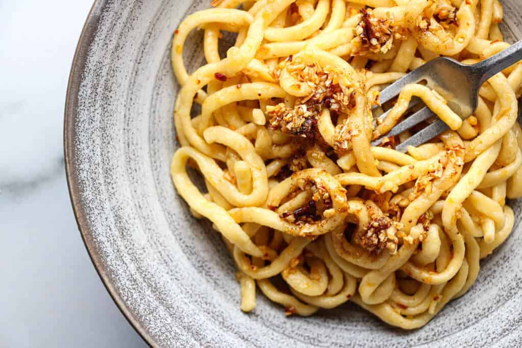 My copycat Trader Joe's Chili Onion Crunch on top of a bowl of linguine