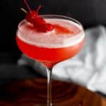 A finished Mary Pickford cocktail garnished with some cherries