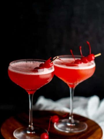 Two Mary Pickford Cocktails garnished with cherries