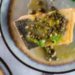 Salmon Meuniere on a plate with lemons