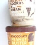 Two unopened containers of Trader Joe's Light Ice Cream. Cookies and cream on top and chocolate peanut butter is on bottom