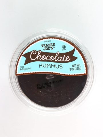 An unopened container of Trader Joe's Chocolate Hummus on a white surface