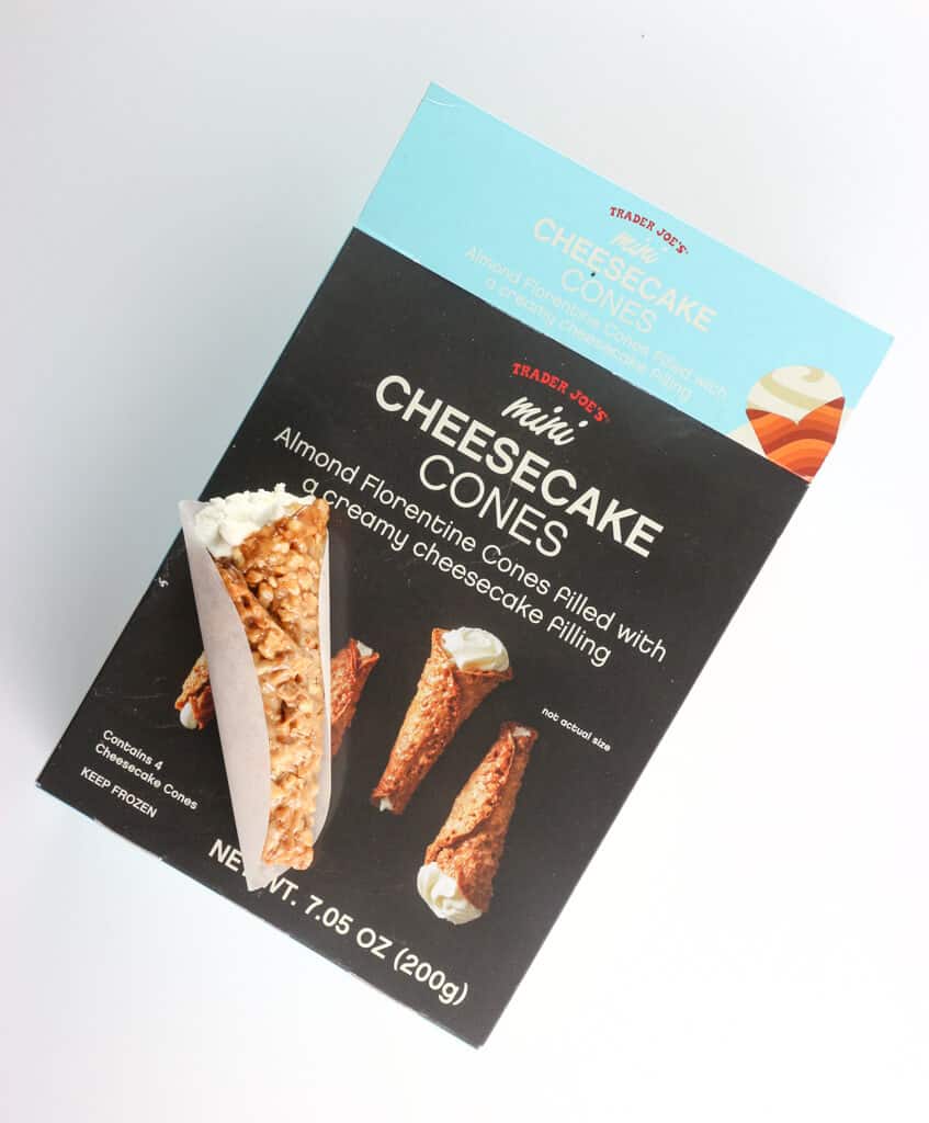 An open box of Trader Joe's Mini Cheesecake Cones showing what one cone looks like