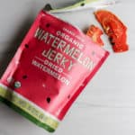 An open bag of Trader Joe's Organic Watermelon Jerky showing two slices sticking out