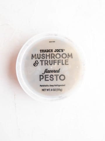 An unopened container of Trader Joe's Mushroom and Truffle flavored pesto