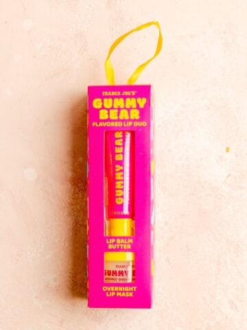 An unopened Trader Joe's Gummy Bear Duo on a pink surface.