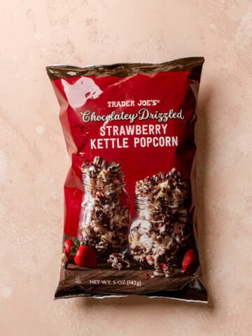 An unopened bag of Trader Joe's Chocolatey Drizzled Strawberry Kettle Popcorn.