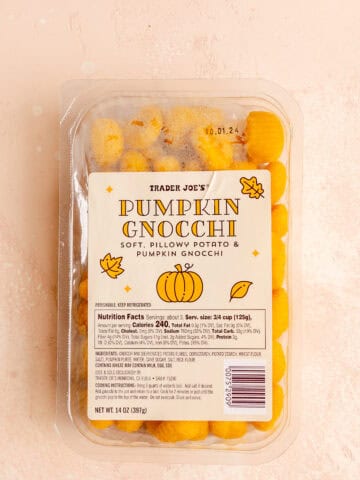 Trader Joe's Pumpkoin Gnocchi unopened on a pink surface.