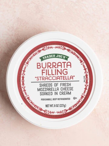 Trader Joe's Burrata Filling Stracciatella on a pink surface.
