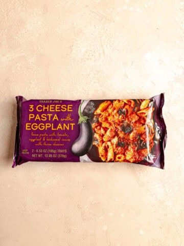 An unopened package of. Trader Joe's 3 Cheese Pasta with Eggplant.