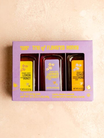 An unopened package of A trio of flavored honey.