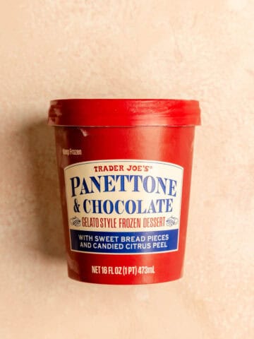An unopened package of Trader Joe's Panettone and Chocolate Gelato on a pink surface.