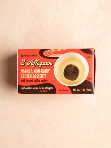 An unopened package of Trader Joe's 2 Affogatos on a pink surface.