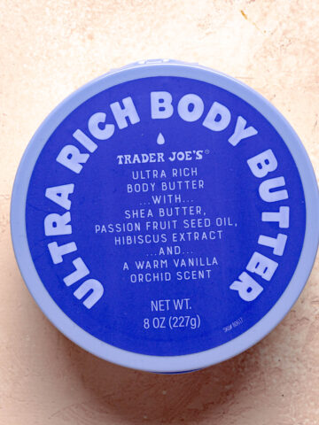 Trader Joe's Ultra Rich Body Butter on a pink surface.
