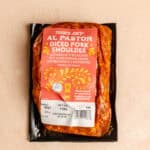 An unopened bag of Trader Joe's Al Pastor Diced Pork Shoulder.