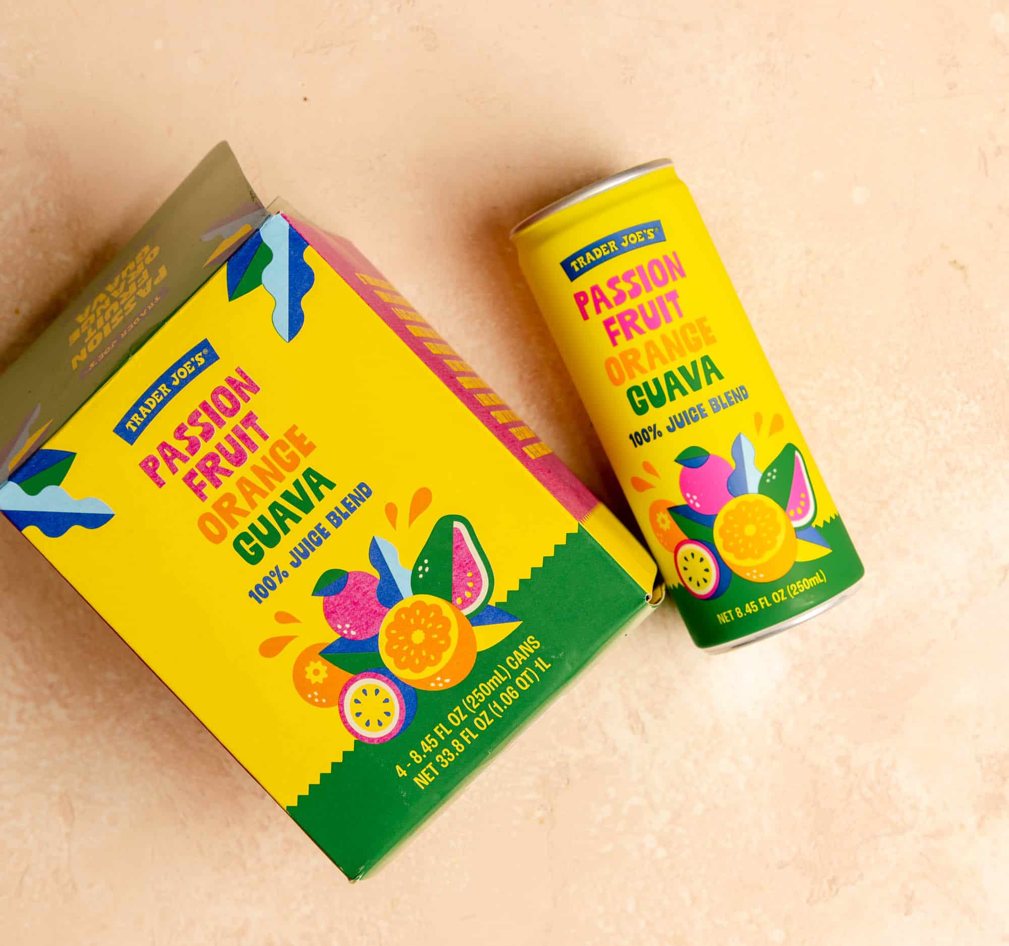 An open box of Trader Joe's Passion Fruit Orange Guava Juice showing the can.