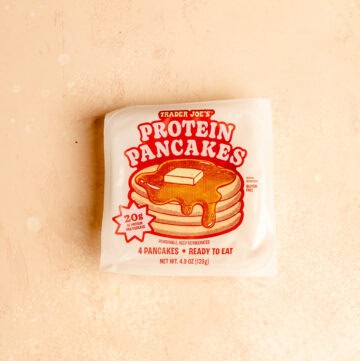 Trader Joe's Protein Pancakes unopened on a pink surface.