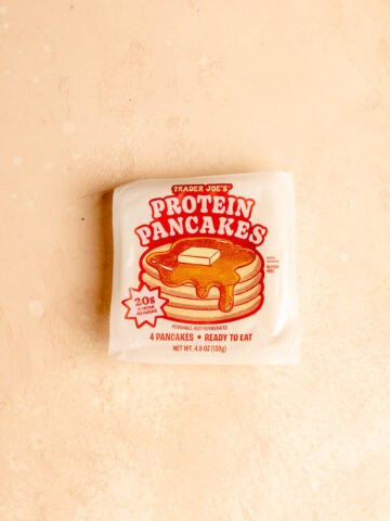 Trader Joe's Protein Pancakes unopened on a pink surface.