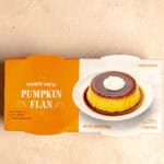 An unopened package of Trader Joe's Pumpkin Flan on a pink surface.
